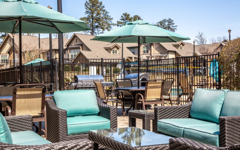 Outdoor patio with gas grills at Chapel Watch Village