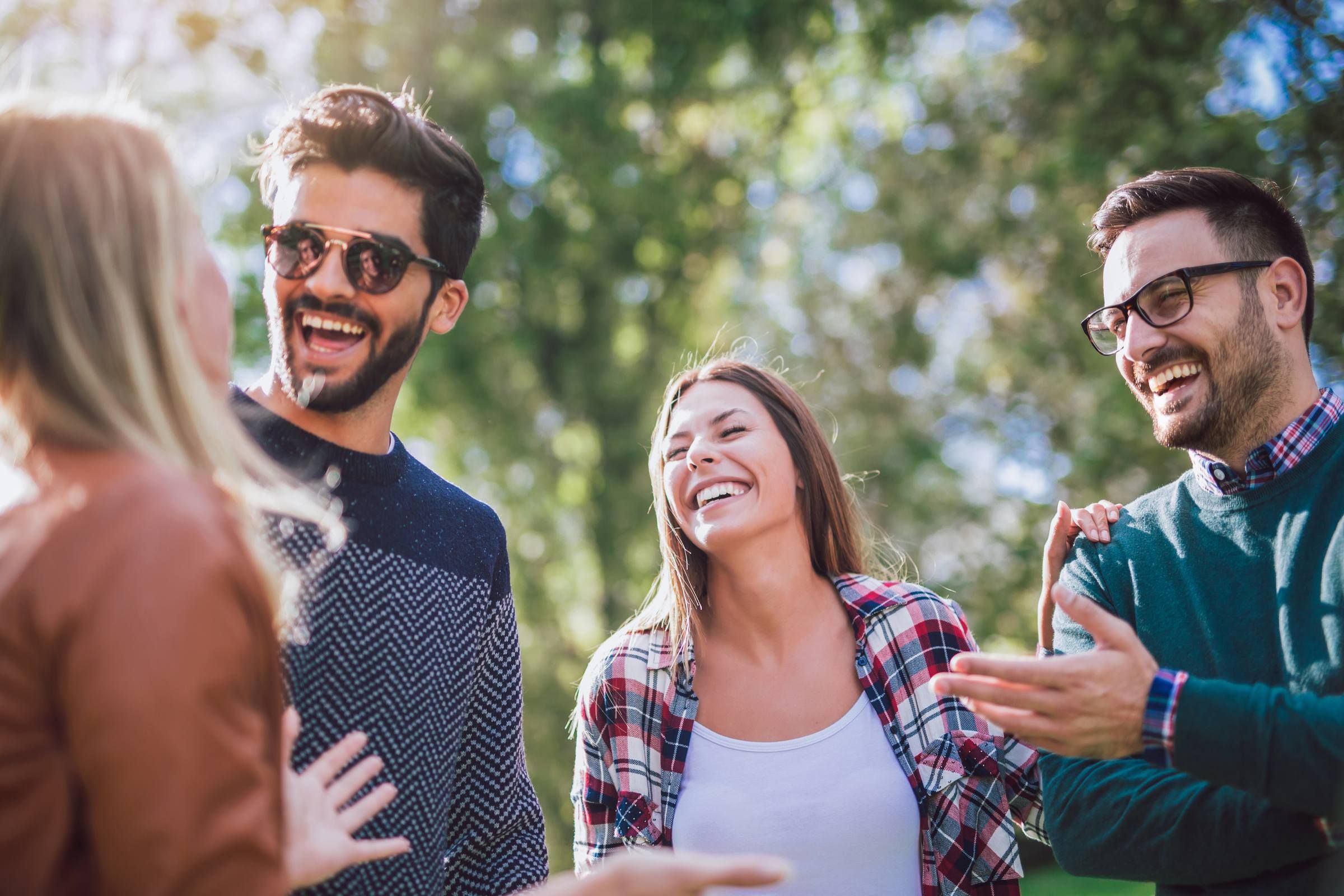 Group of friends having fun outdoors in park