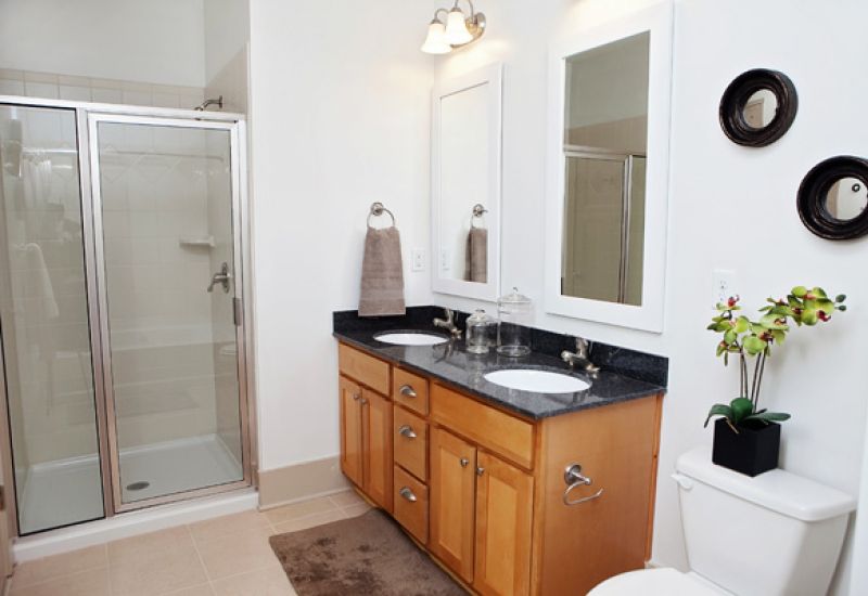 The Townhomes at Chapel Watch Village bathroom with walk-in glass shower and double vanity and his and hers sinks