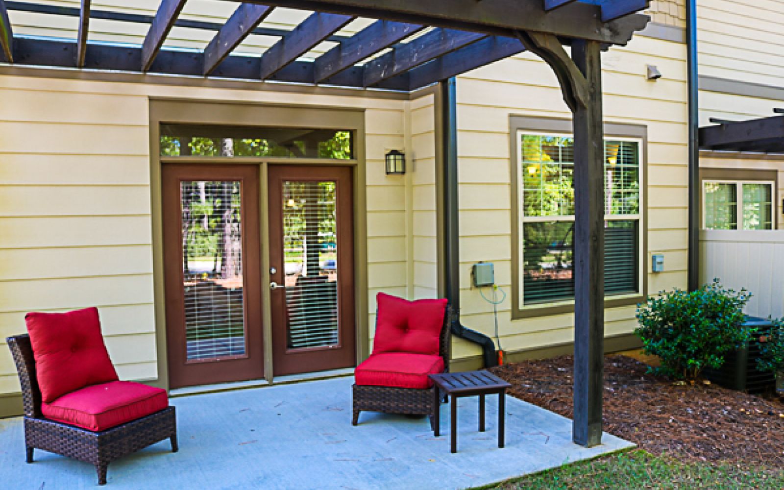 The Townhomes at Chapel Watch Village private patio with chairs and grass
