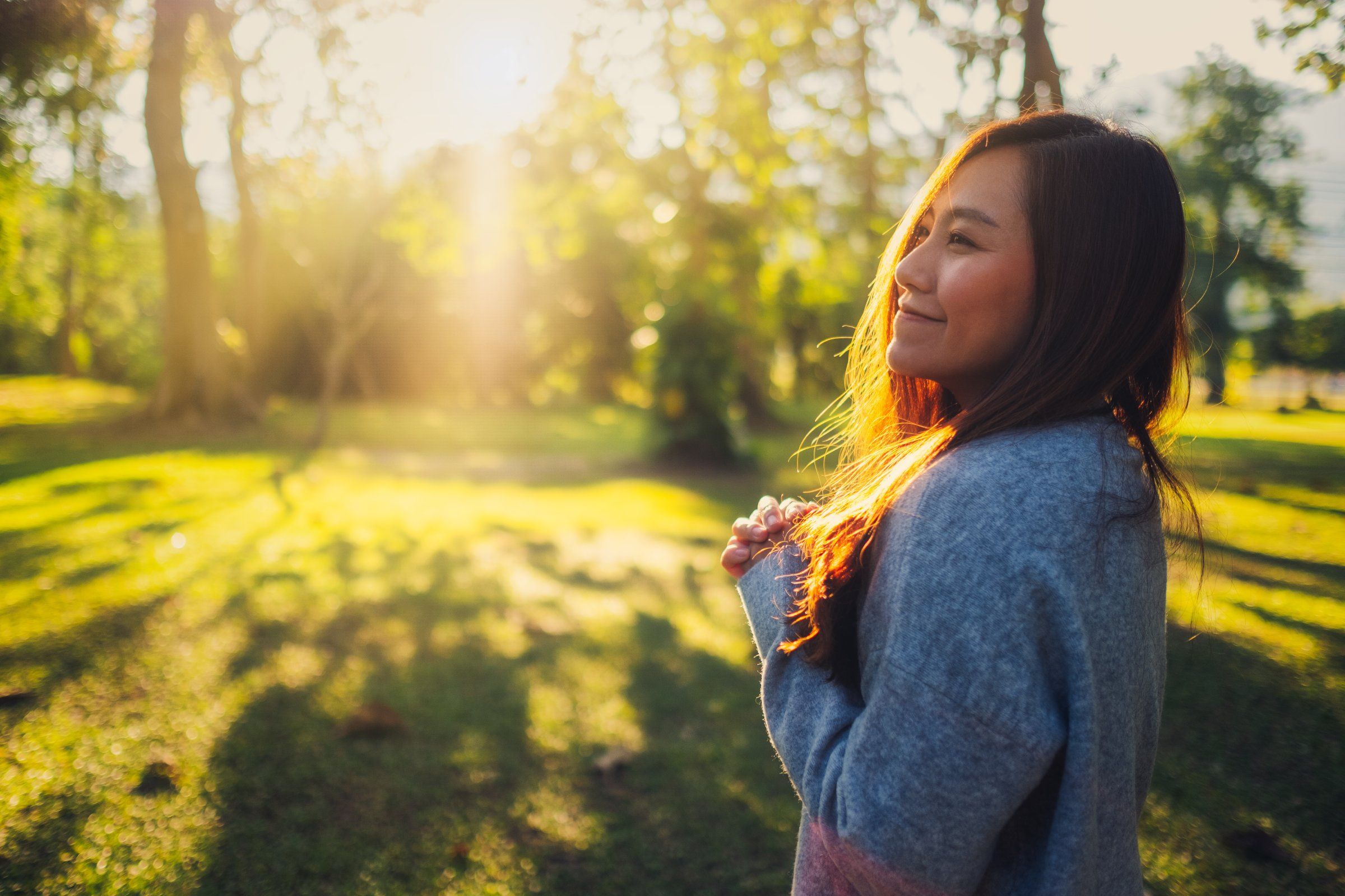 The Townhomes at Chapel Watch Village in Chapel Hill, NC with a woman smiling and appreciating the beauty of nature around her