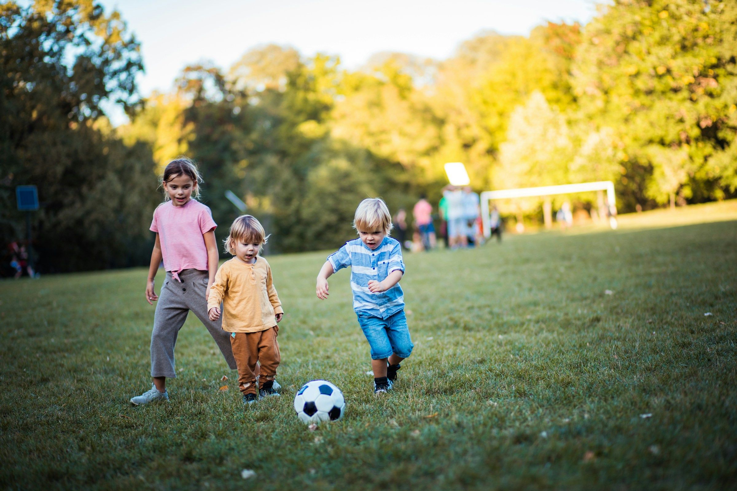 The Townhomes at Chapel Watch Village in Chapel Hill, NC with children playing soccer at a neighborhood park