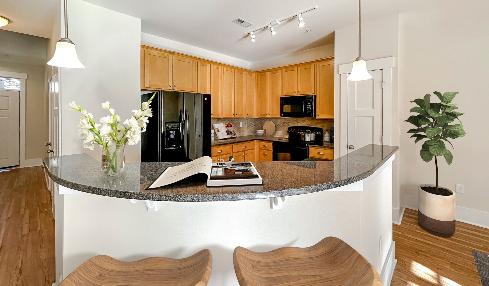 The Townhomes at Chapel Watch Village kitchen island bar and bar stools with floor-to-ceiling cabinetry