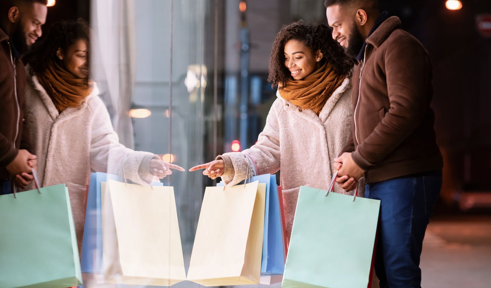 The Townhomes at Chapel Watch Village in Chapel Hill, NC with a happy couple with retail shopping bags looking into a store window at a shopping mall