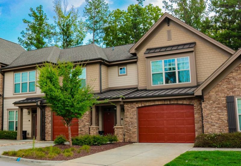 The Townhomes at Chapel Watch Village community exterior with private garages and driveways