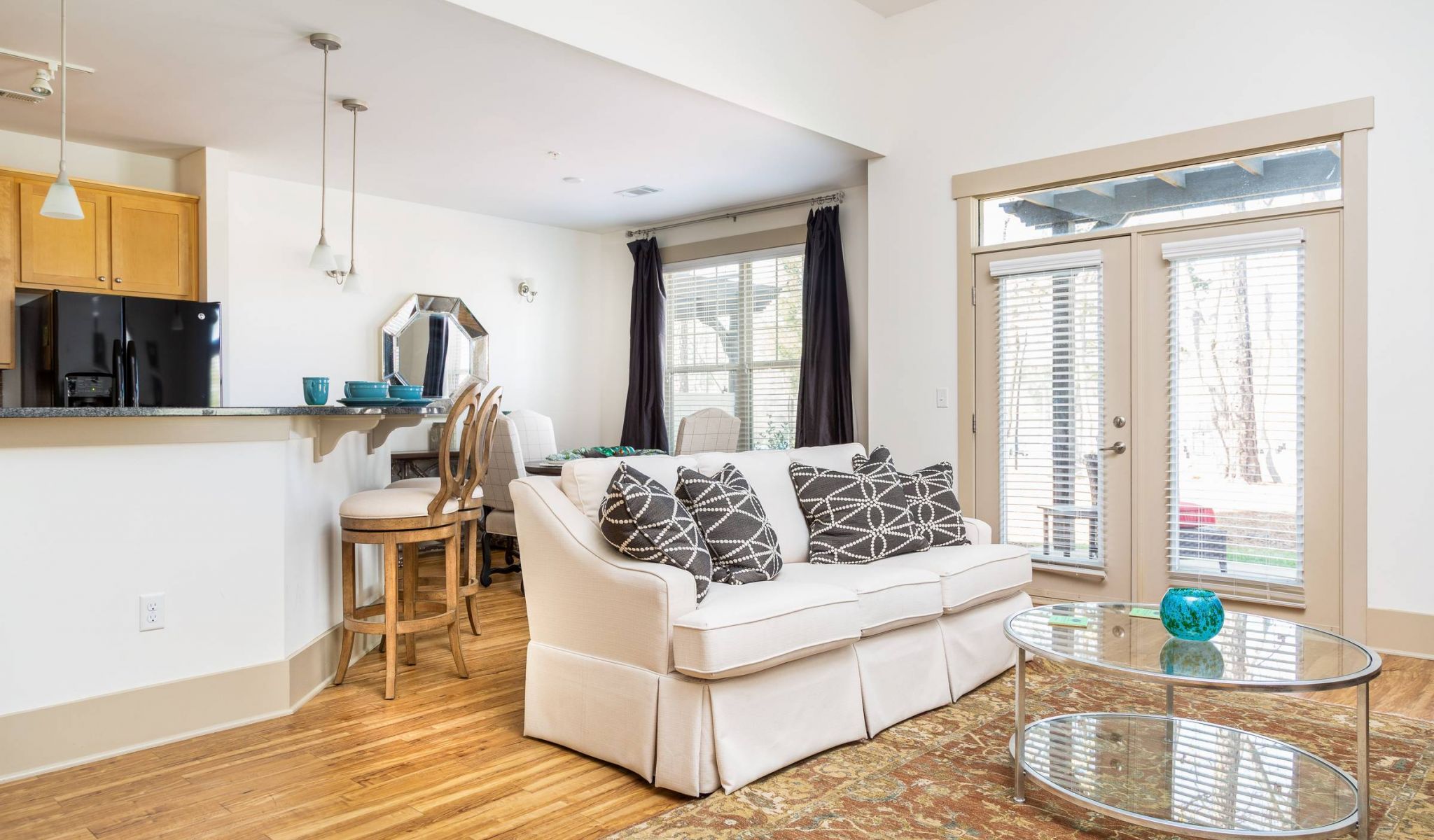 The Townhomes at Chapel Watch Village living room with couch, coffee table, and lots of natural light